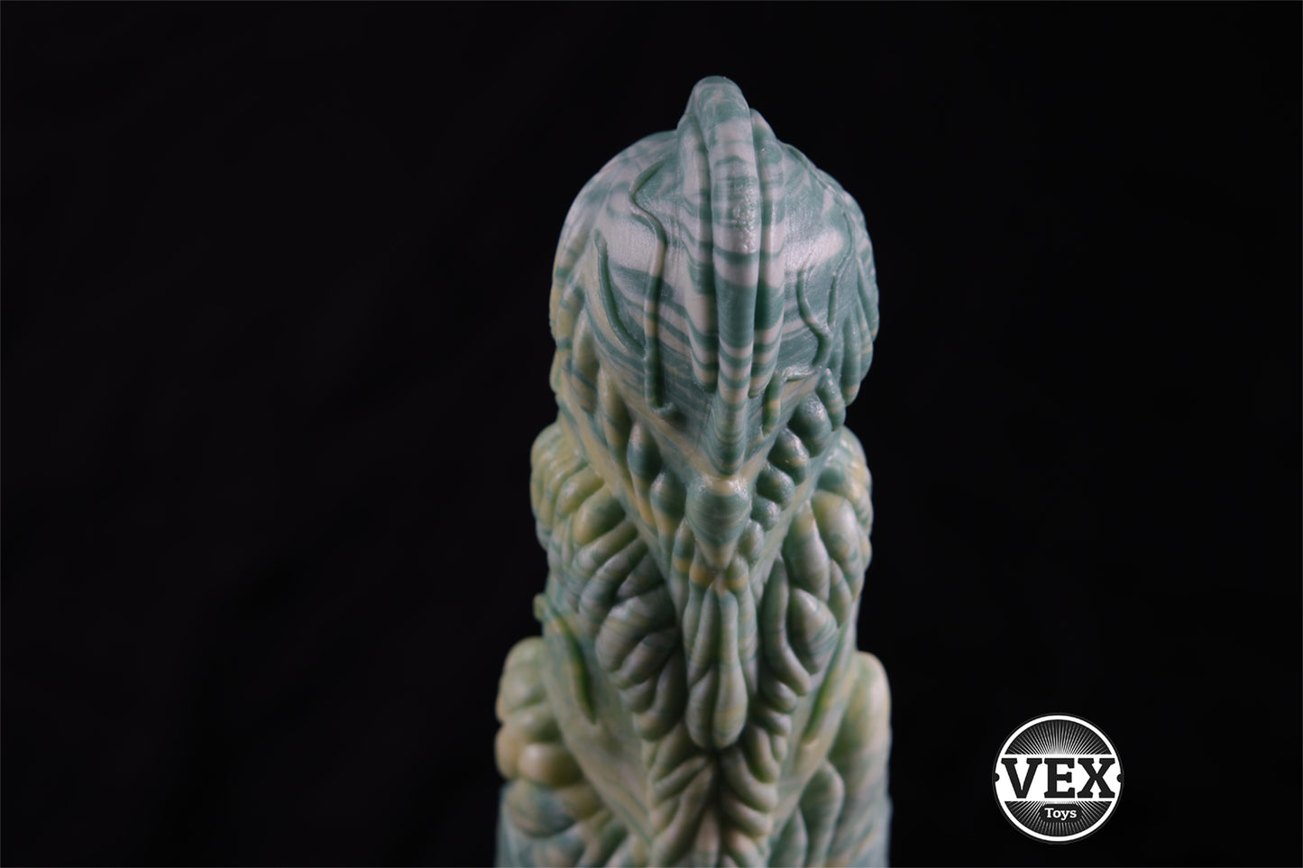 Decorative fantasy sex toy with intricate design on a black background, featuring the brand 'VEX'.