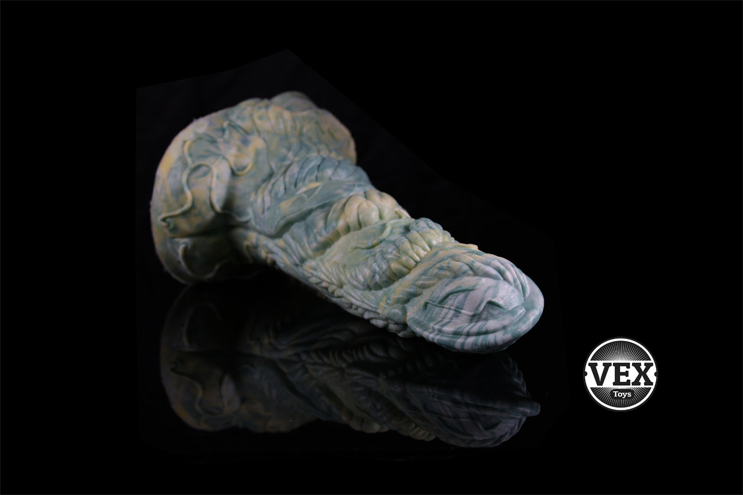 Textured dildo on a black background with VEX logo.