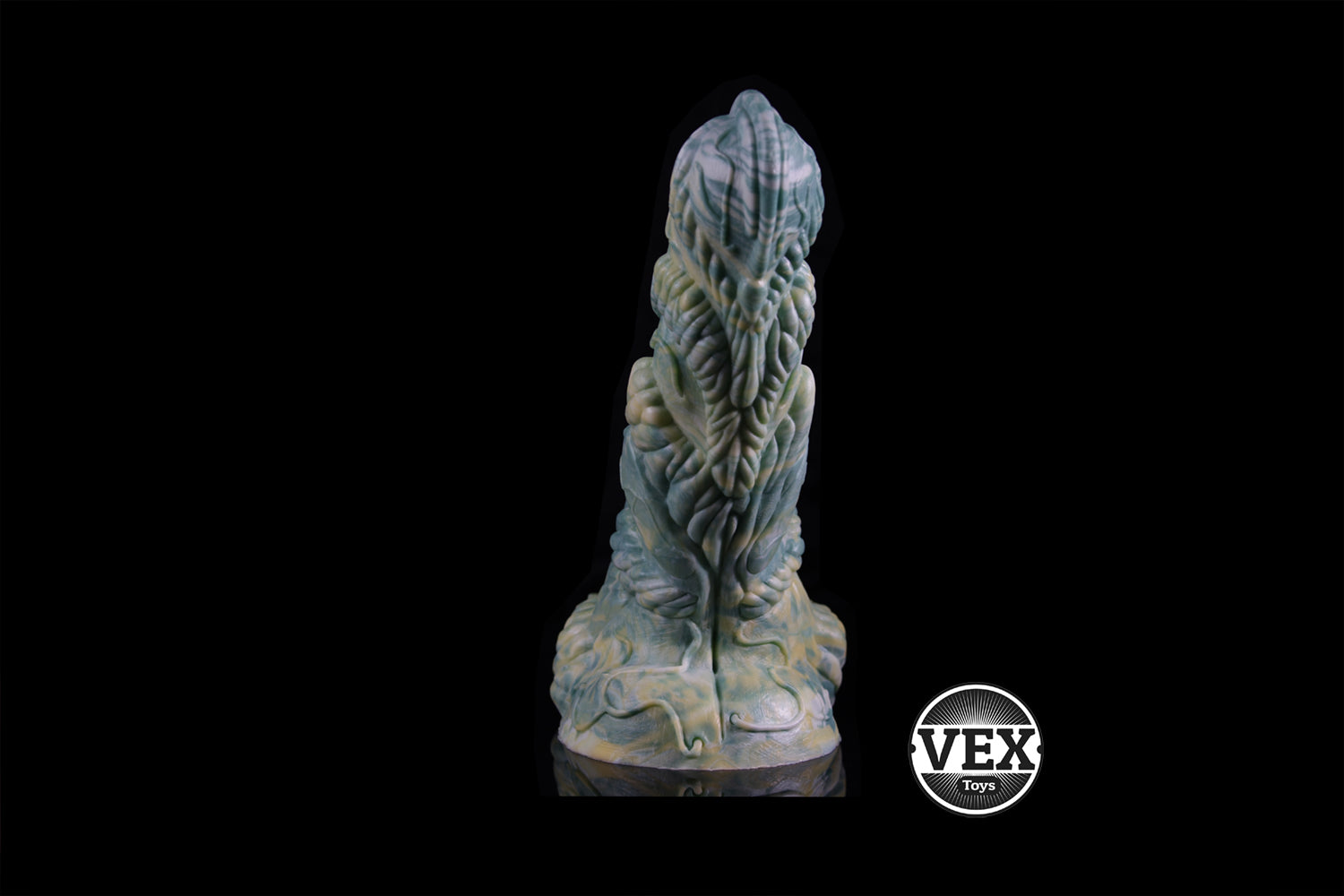 Platinum Silicone sculpture with intricate design on a black background, featuring the brand 'VEX'.