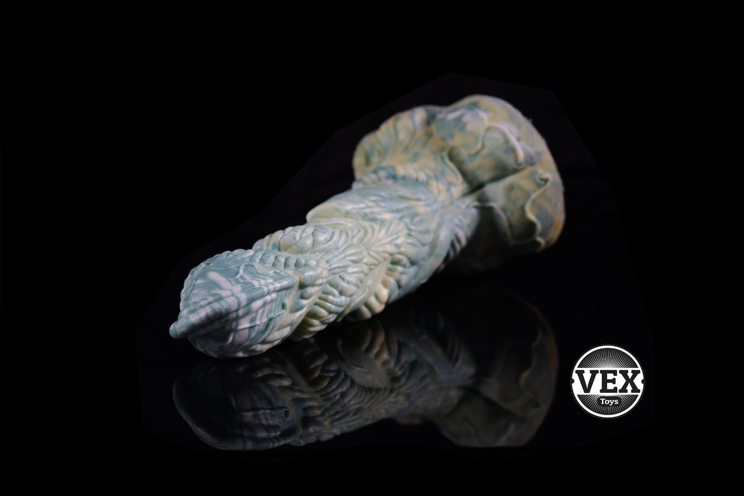 Decorative item with intricate patterns on a black background, featuring the VEX logo.